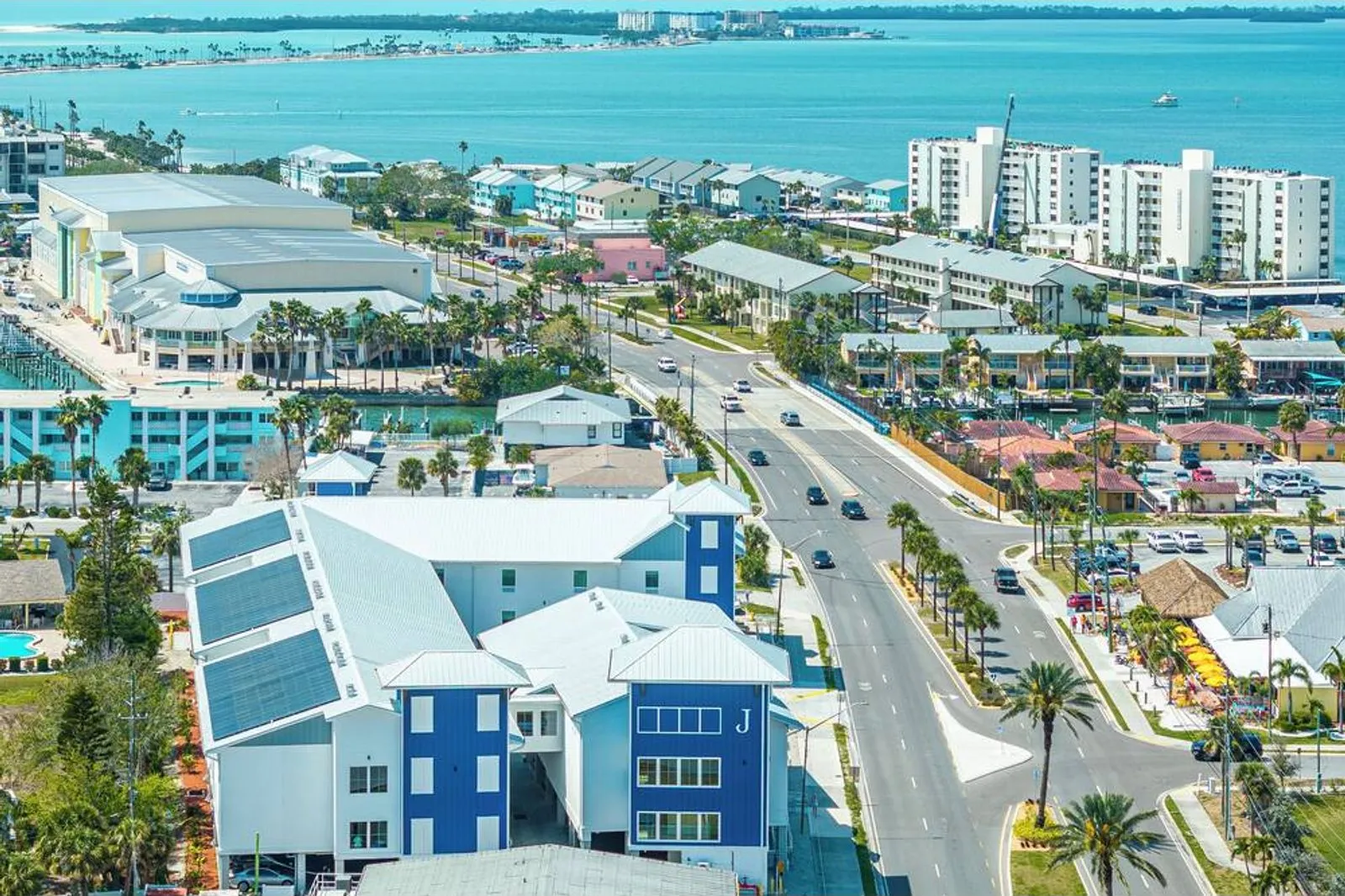 Aerial view of The J Hotel's blue and white buildings, Causeway Boulevard and St. Joseph Sound
