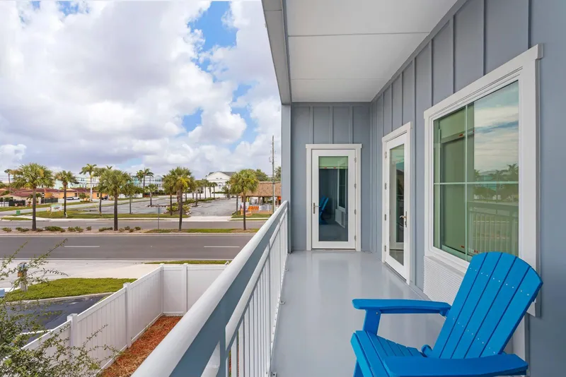 Balcony walkway with a blue Adirondack chair
