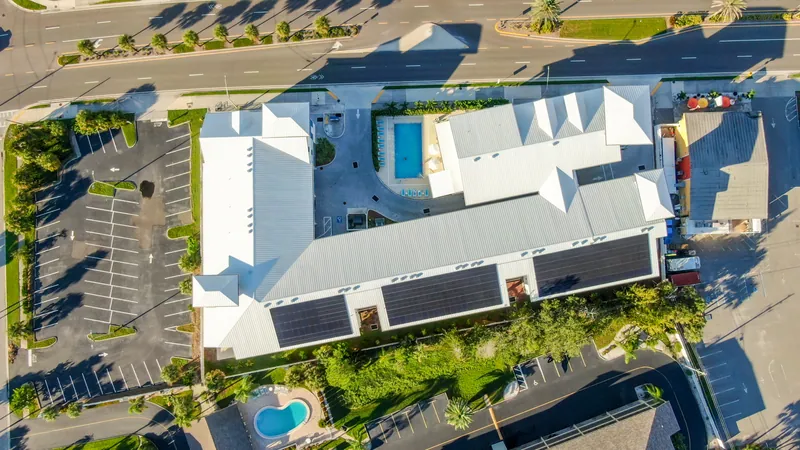 The J from directly above, with solar panels on the roof and the pool