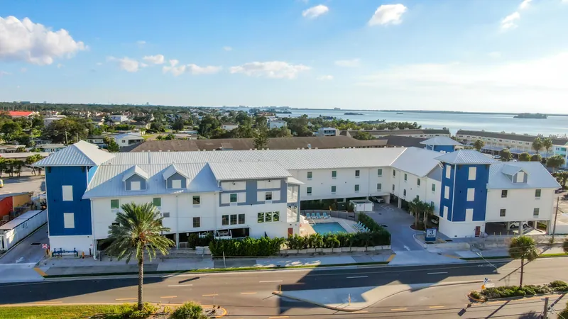 Aerial view of The J Hotel on Causeway Boulevard with the water behind it