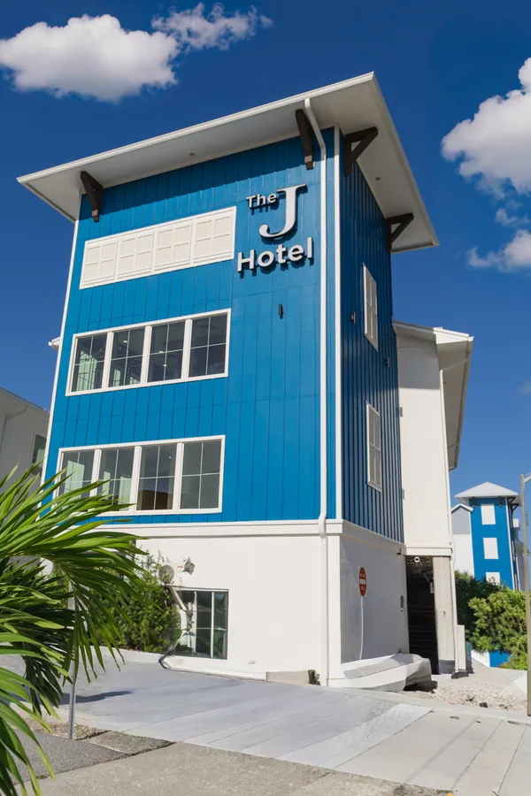 The J Hotel tower with its name on the blue siding